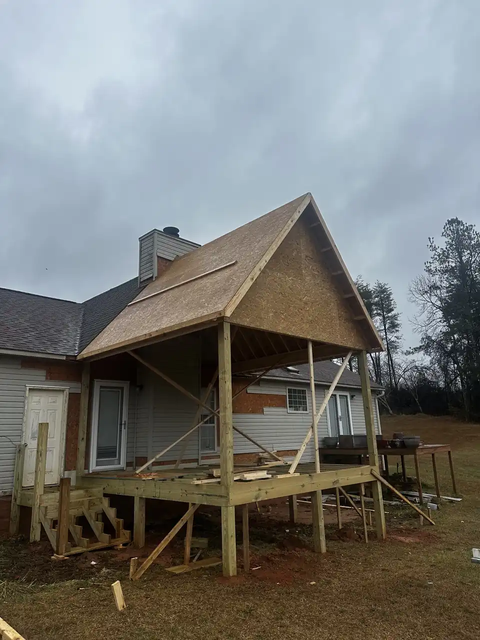 Superior Porchworks framing a gabled screen porch and raised deck on a home