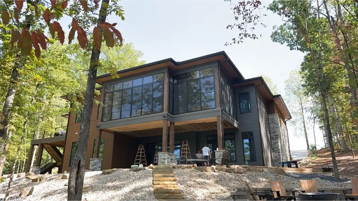 Modern wooded home with a large upper-level porch enclosed with Eze-Breeze panels