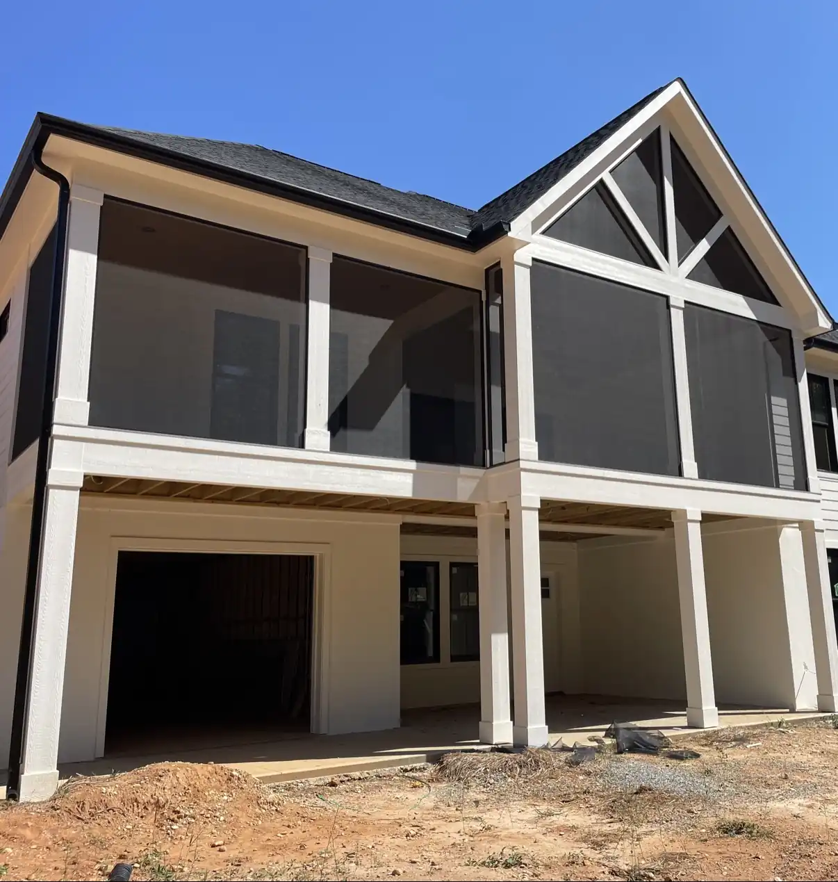 White two-story home with a large upper-level gabled screen porch